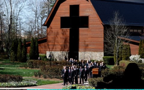 The casket carrying the body of Rev Billy Graham is carried to his funeral service at the Billy Graham Library  - Credit: Getty Images