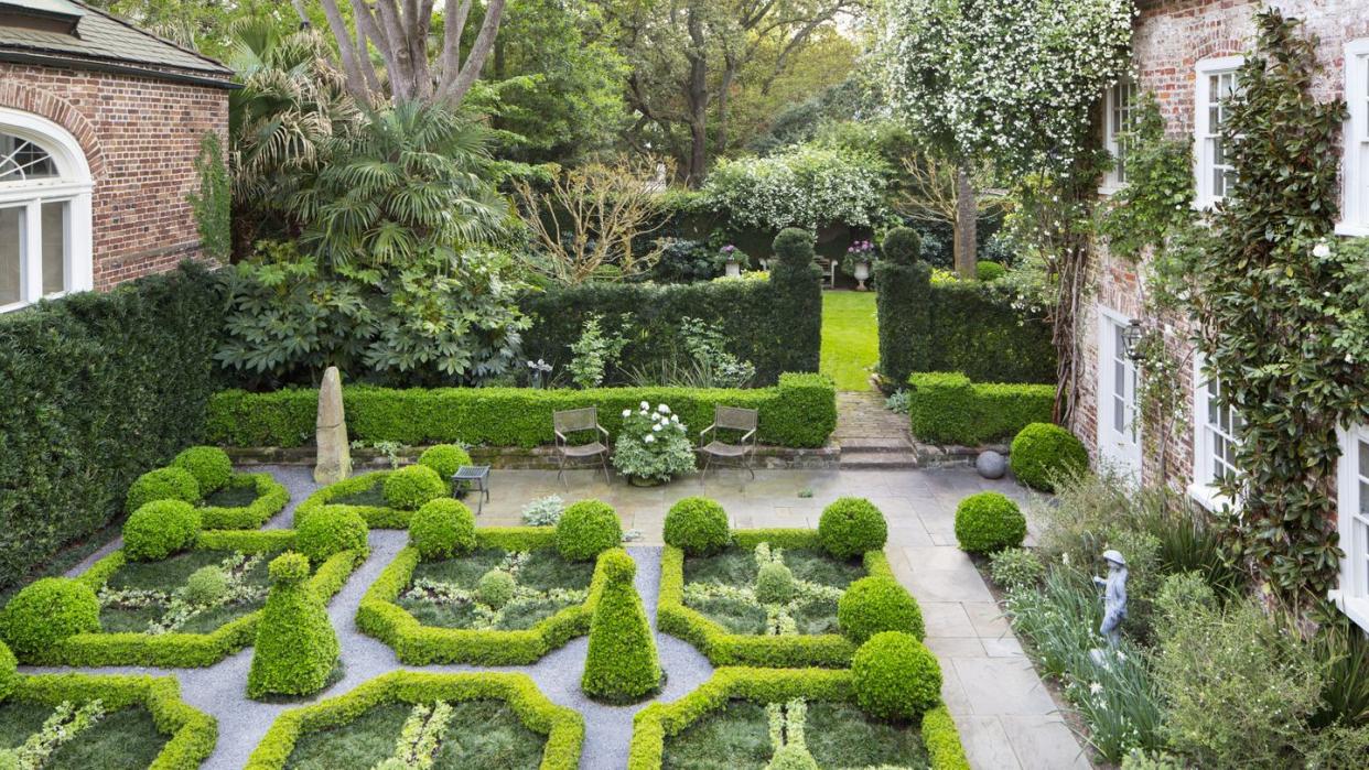 18th century charleston, south carolina, home design by ben lenhardt in the parterre garden, kingsville boxwood borders with corner globes of japanese boxwood frame variegated asiatic jasmine knots and smaller spheres of oregano