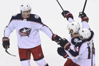 Columbus Blue Jackets defenseman Zach Werenski (8) celebrates his goal against the Toronto Maple Leafs with Boone Jenner (38) and Gustav Nyquist (14) during the first period of an NHL hockey playoff game Sunday, Aug. 9, 2020, in Toronto. (Nathan Denette/The Canadian Press via AP)