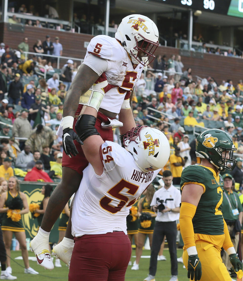 Iowa State running back Cartevious Norton (5) is lifted by Iowa State offensive lineman Jarrod Hufford (54) after scoring a touchdown in the first half of an NCAA college football game, Saturday, Oct. 28, 2023, in Waco, Texas. (Jerry Larson/Waco Tribune-Herald via AP)