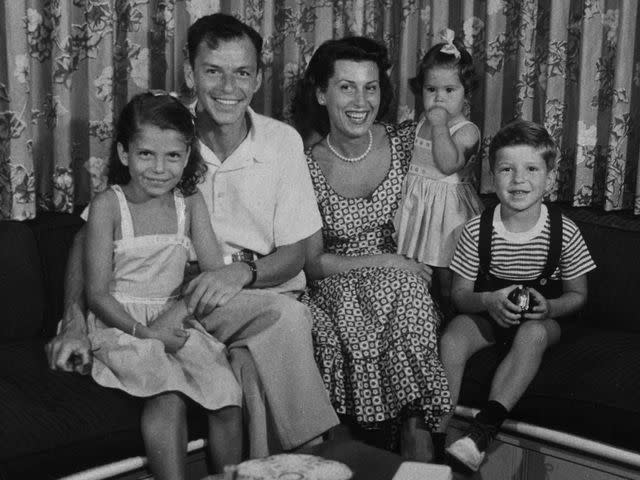 <p>Hulton Archive/Getty </p> Frank Sinatra with Nancy Barbato and their children Nancy, Tina, and Frank Jr. circa 1950.