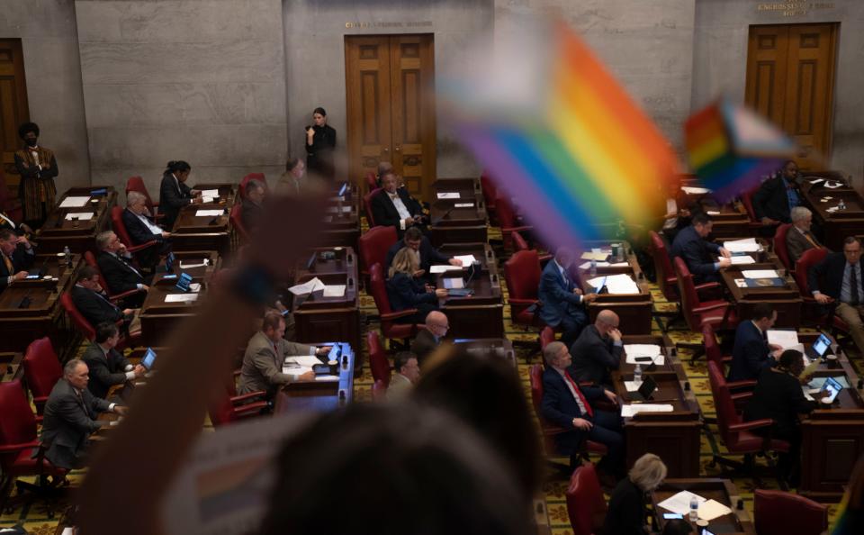 Protesters stand in the gallery with Pride flags during the House session at the state Capitol building in Nashville, Tennessee, Monday, Feb. 26, 2024.