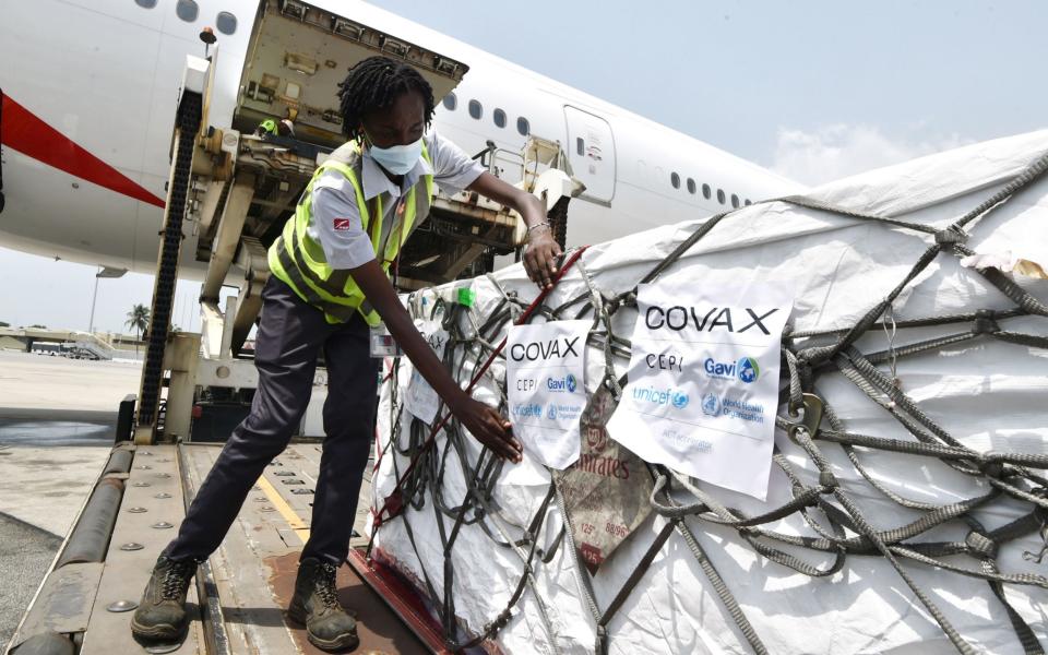 Oxford-AstraZeneca vaccines are removed from a plane at Felix Houphouet Boigny airport of Abidjan, courtesy of Covax - AFP