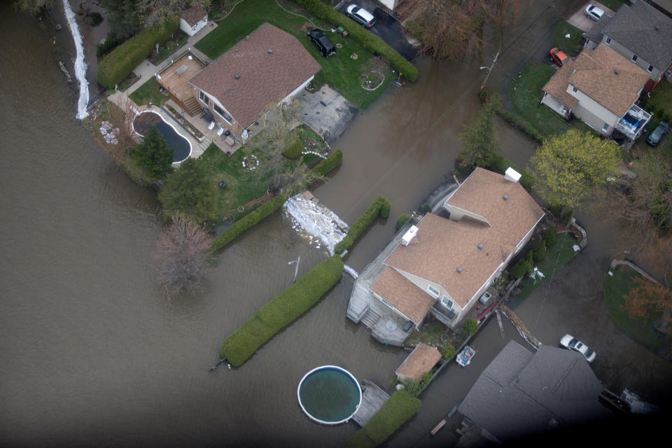 An overhead view showing homes in a flooded Montreal suburb of Pierrefonds, Quebec, Canada May 11, 2017. REUTERS/Christinne Muschi