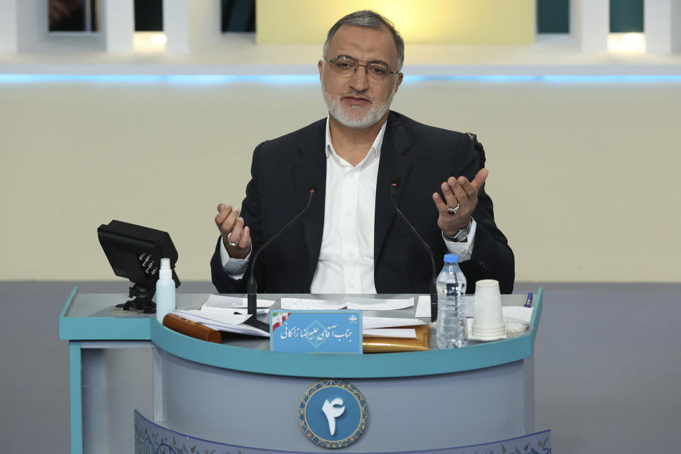 In this photo made available by the government-affiliated Young Journalists Club, presidential candidate Alireza Zakani speaks in a televised debate in a state-run television studio, in Tehran, Iran, on Saturday, June 5, 2021. Elections are scheduled for June 18. (Morteza Fakhri Nezhad/YJC via AP)