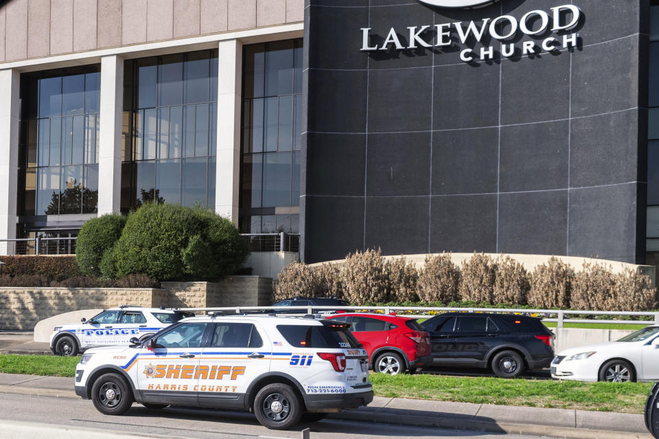 Emergency vehicles line the feeder road outside Lakewood Church during a reported active shooter event, Sunday, Feb. 11, 2024, in Houston. (Kirk Sides/Houston Chronicle via AP)