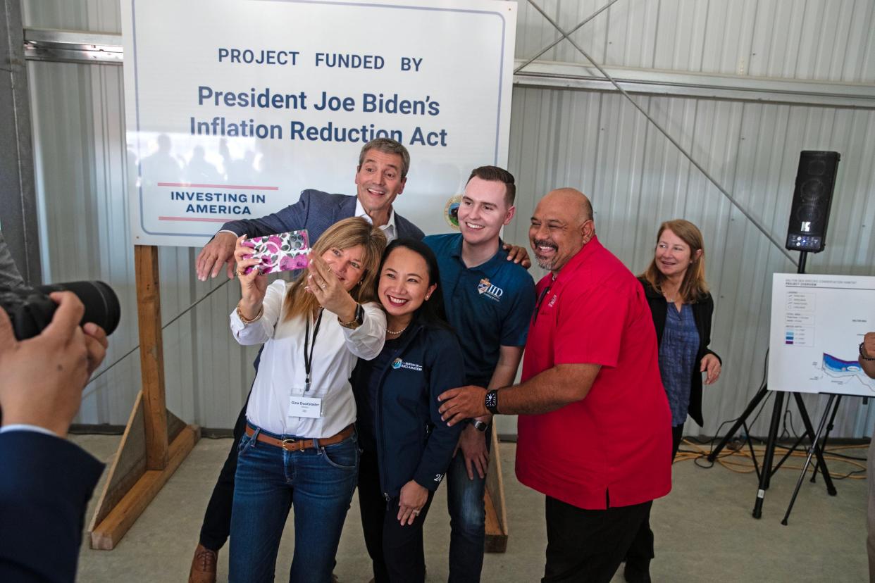 California Natural Resources Agency Secretary Wade Crowfoot, top, jumps into the frame as Imperial Irrigation District Board of Directors take a selfie with Bureau of Reclamation Commissioner Camille Calimlim Touton, center, during their visit to announce the historic $72 million federal funding for Salton Sea restoration efforts in Brawley, Calif., on Thurs., Dec. 7, 2023.