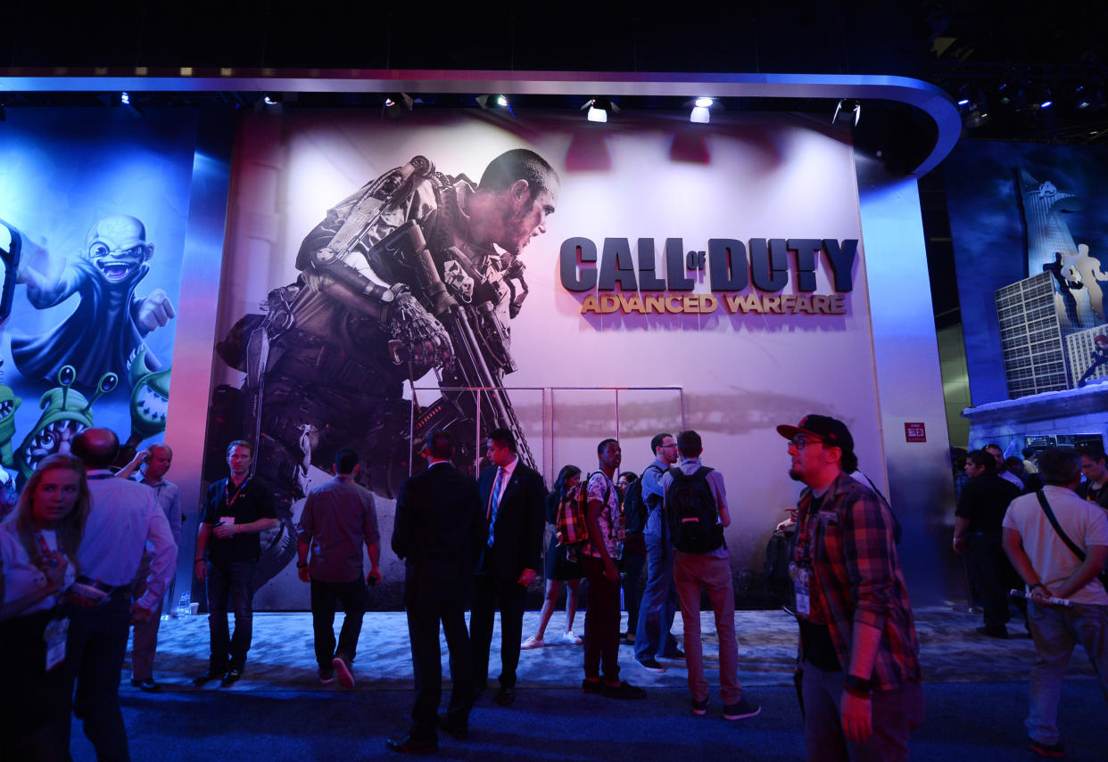 Microsoft  Attendees walk pass a giant billboard promoting the new multiplayer action game 