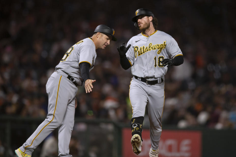 Pittsburgh Pirates' Ben Gamel (18) is greeted by third base coach Mike Rabelo (58) after hitting a home run off San Francisco Giants starting pitcher Carlos Rodón during the sixth inning of a baseball game Friday, Aug. 12, 2022, in San Francisco. (AP Photo/D. Ross Cameron)