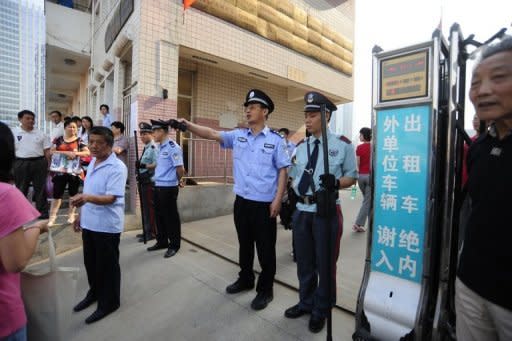 Chinese police and security guards stand outside a school prior to the start of the annual "Gaokao" or college entrance examinations, in Wuhan, China. With just 6.85 million university spots on offer this year, competition is intense, and attempts to cheat are rife -- more than 1,500 people have been arrested on suspicion of selling transmitters and hard-to-detect ear pieces