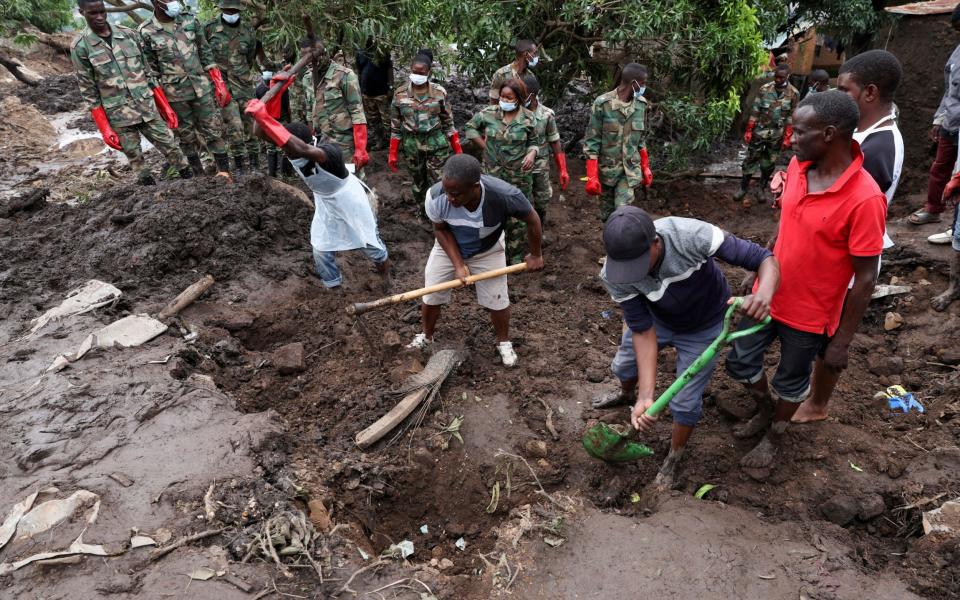 Members of the Malawian Army and locals help the community to recover bodies of victims in Chimwankhunda township in the aftermath of Tropical Cyclone Freddy in Blantyre, Malawi - Esa Alexander/REUTERS