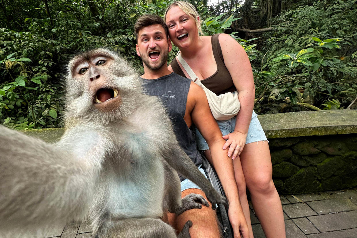 Stunned tourists photobombed by selfie-taking macaque in Bali