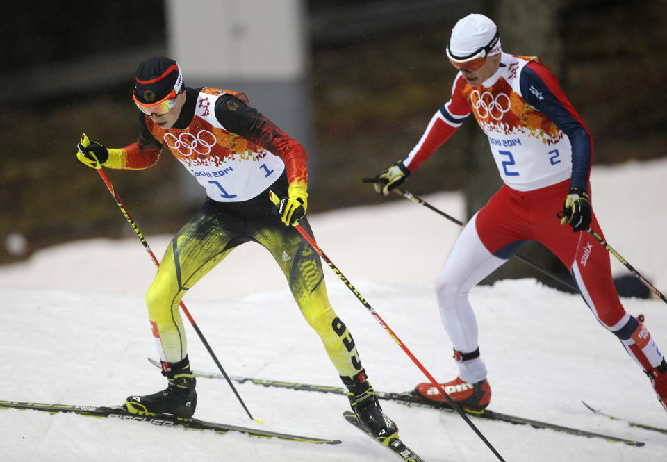 Germany's Eric Frenzel, left, and Norway's Haavard Klemetsen who led after the ski jumping ski during the Nordic combined individual Gundersen large hill competition at the 2014 Winter Olympics, Tuesday, Feb. 18, 2014, in Krasnaya Polyana, Russia. (AP Photo/Gregorio Borgia)