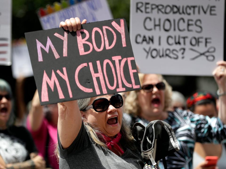 Protesters hold signs at an abortion rally at the Texas State Capitol in 2019.