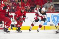 Nov 18, 2018; Raleigh, NC, USA; New Jersey Devils center Blake Coleman (20) clears the puck away from Carolina Hurricanes right wing Justin Williams (14) during the third period at PNC Arena. Mandatory Credit: James Guillory-USA TODAY Sports