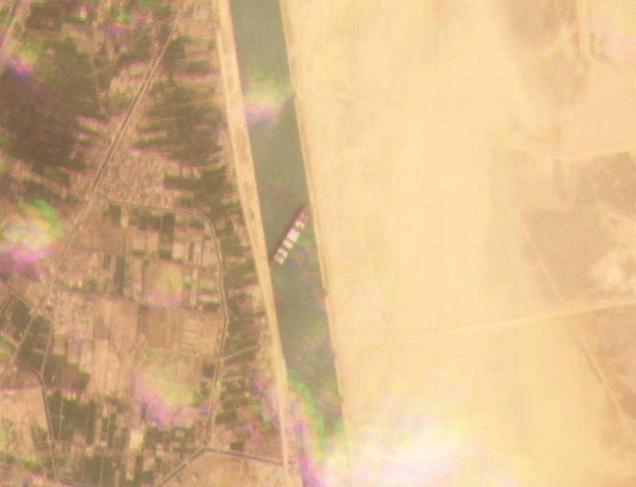 This satellite image from Planet Labs Inc. shows the cargo ship MV Ever Given stuck in the Suez Canal near Suez, Egypt, Tuesday, March 23, 2021. A cargo container ship that's among the largest in the world has turned sideways and blocked all traffic in Egypt's Suez Canal, officials said Wednesday, March 24, 2021, threatening to disrupt a global shipping system already strained by the coronavirus pandemic.