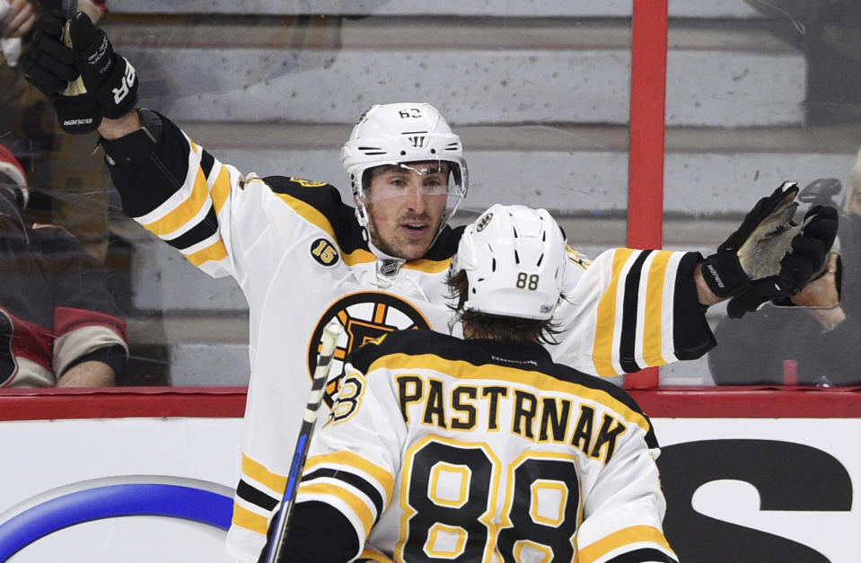 Boston Bruins left wing Brad Marchand (63) celebrates his game-winning goal with teammate David Pastrnak during the third period of the first round of NHL Stanley Cup playoff hockey action in Ottawa on Wednesday, April 12, 2017. (Sean Kilpatrick/The Canadian Press via AP)