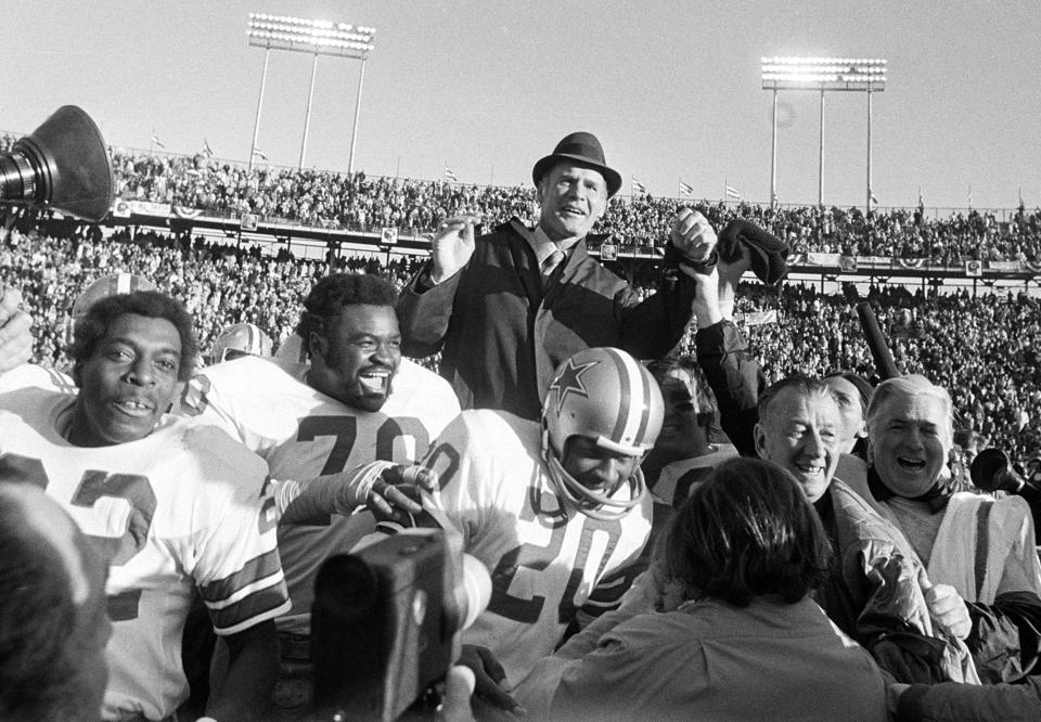 FILE - Dallas Cowboys coach Tom Landry is carried off the field on the shoulders of players after they defeated the Miami Dolphins 24-3 to win the Super Bowl in New Orleans on Jan. 16, 1972. Among the players are Bob Hayes (22), Rayfield Wright (70) and Mel Renfro (20). Wright, the Pro Football Hall of Fame offensive tackle nicknamed “Big Cat” who went to five Super Bowls in his 13 NFL seasons with the Cowboys, has died. He was 76. Wright's family confirmed his death Thursday, April 7, 2022, to the Pro Football Hall of Fame. (AP Photo, File)