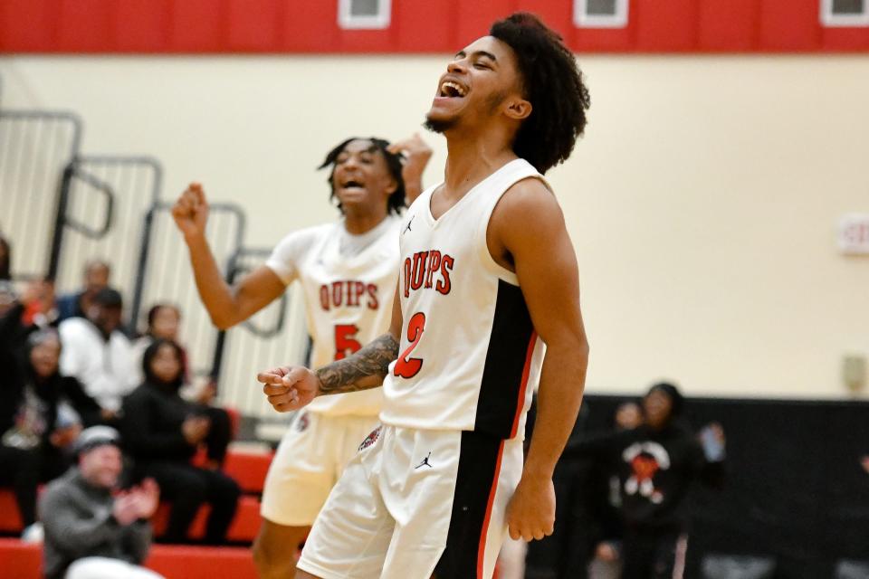 Aliquippa's Quentin Goode and Demarkus Walker react after Jayace Williams makes a shot while drawing a foul near the end of the Quips game against Shenango.