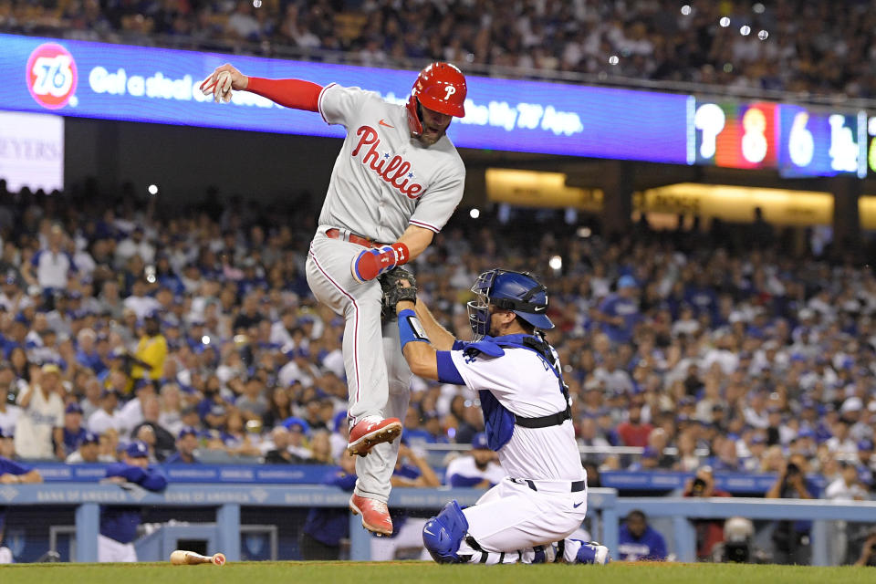 Philadelphia Phillies' Bryce Harper, left, is tagged out at home by Los Angeles Dodgers catcher Austin Barnes while trying to score on a single by Nick Castellanos during the sixth inning of a baseball game Friday, May 13, 2022, in Los Angeles. (AP Photo/Mark J. Terrill)