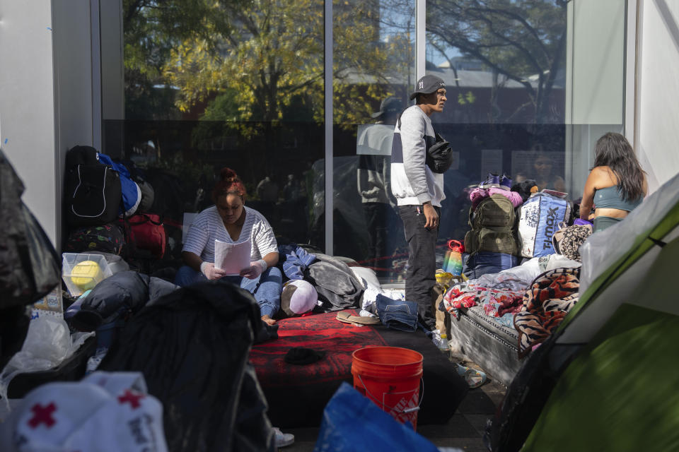 Migrants are camped outside of the 1st District police station, Saturday, Oct. 7, 2023, in Chicago. (AP Photo/Erin Hooley)