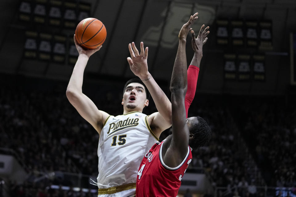 Purdue center Zach Edey (15) shoots over Ohio State center Felix Okpara (34) in the second half of an NCAA college basketball game in West Lafayette, Ind., Sunday, Feb. 19, 2023. Purdue defeated Ohio State 82-55. (AP Photo/Michael Conroy)