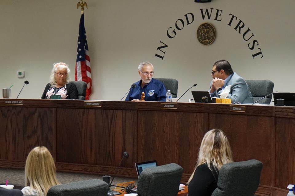 From left, Nye County Commissioners Debra Strickland, Frank Carbone and Leo Blundo discuss appointing a new county clerk on July 19, 2022 in Pahrump, Nev. The resignation of a county elections clerk in a rural county in Nevada has opened a window into the long-term consequences of election conspiracy theories. Officials in Nye County have recommended scrapping voting machines in favor of hand-counting all ballots — which would be more than 20,000 in a typical general election.(AP Photo/Samuel Metz)