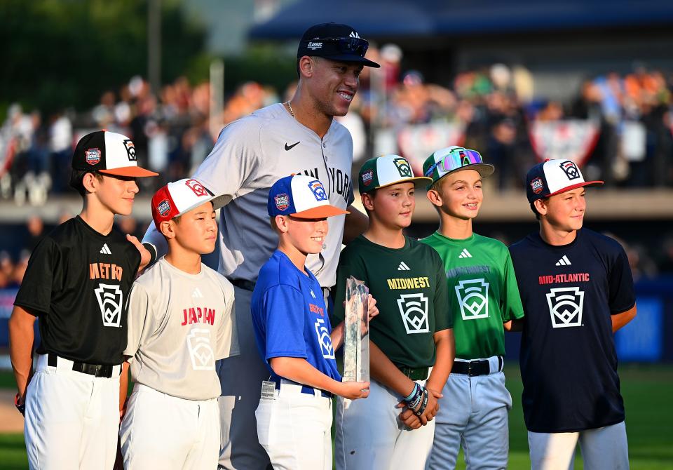 Aaron Judge poses with Little League players prior to the game against the Detroit Tigers at Bowman Field.