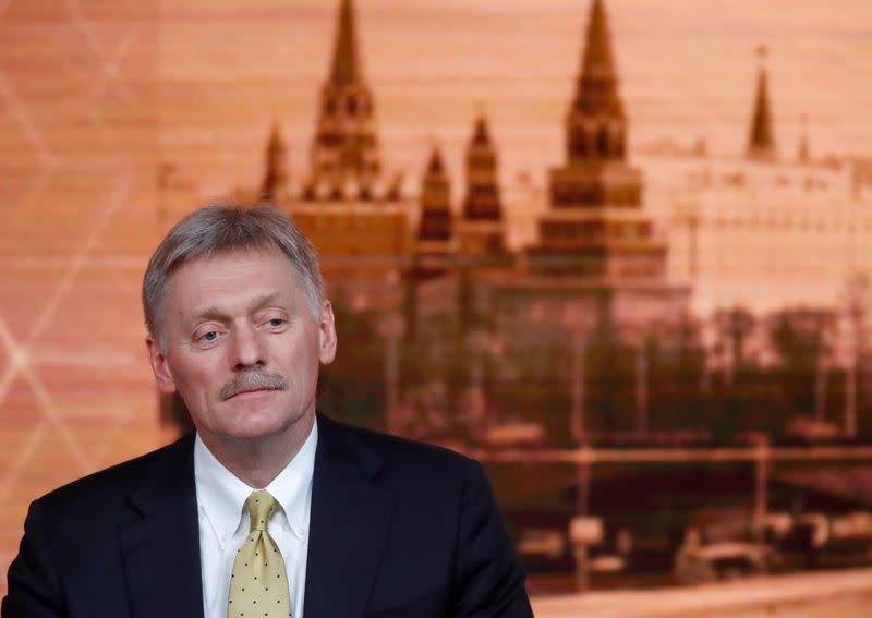 Kremlin spokesman Dmitry Peskov listens during Russian President Vladimir Putin's annual end-of-year news conference in Moscow