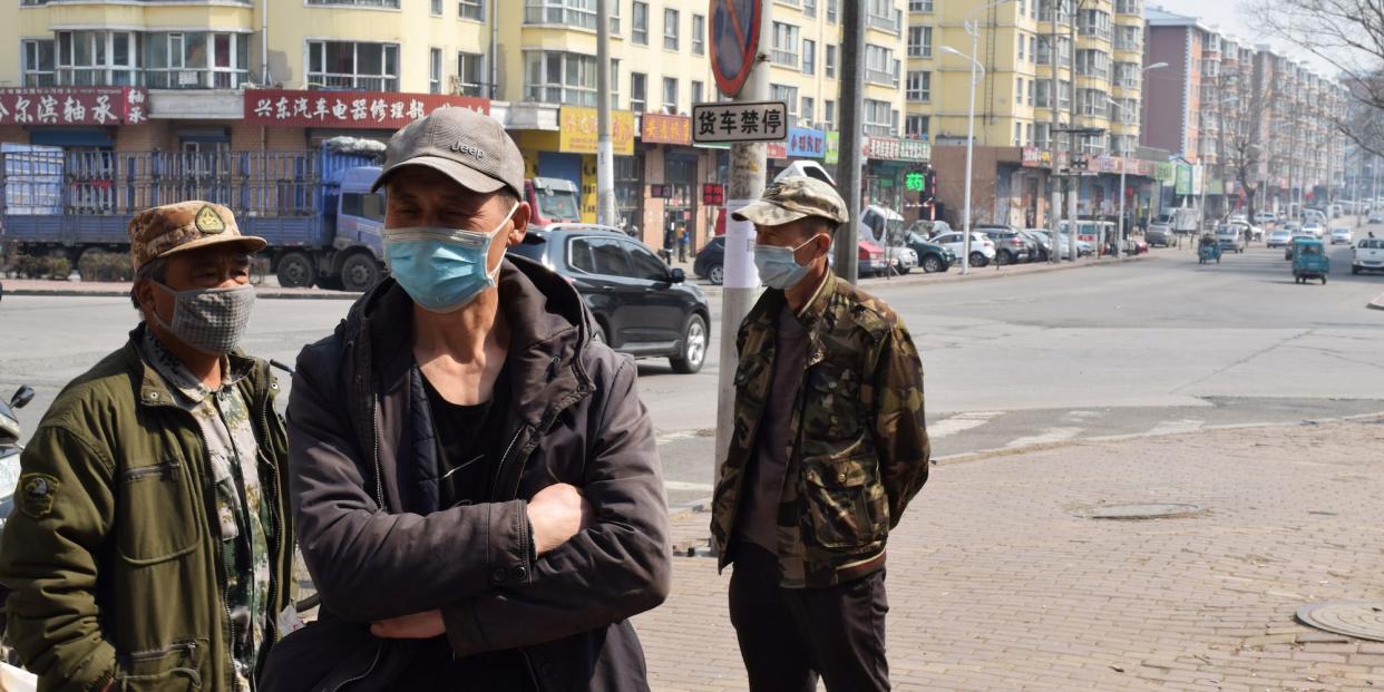 Daily wage workers wait for work at a corner following an outbreak of the coronavirus in Suifenhe, a Chinese city bordering Russia, in Heilongjiang province, in April.