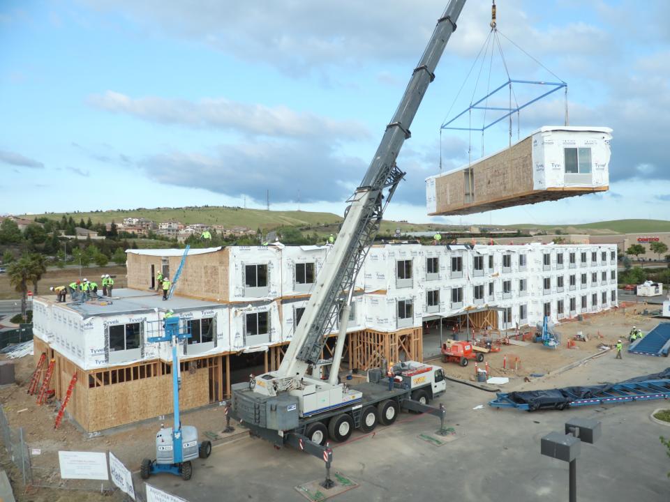 Built section-by-section in a factory, hotel units are shipped to a site and stacked, sometimes practically overnight. Photo credit: Guerdon Modular Buildings.