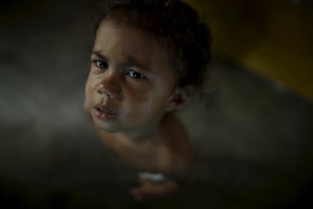 Laiane Sophie cries as her mother Rosana Vieira Alves holds her other daughter, 4-month-old Luana Vieira (not pictured) who was born with microcephaly, at their home in Olinda, Brazil, February 3, 2016. REUTERS/Ueslei Marcelino