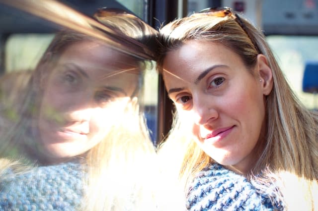 Portrait of smiling young woman relaxing in a train