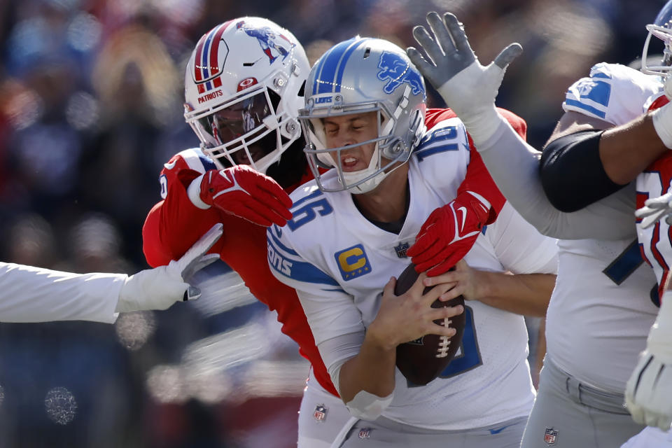 New England Patriots linebacker Matthew Judon, left, sacks Detroit Lions quarterback Jared Goff, center, during the first half an NFL football game, Sunday, Oct. 9, 2022, in Foxborough, Mass. (AP Photo/Michael Dwyer)