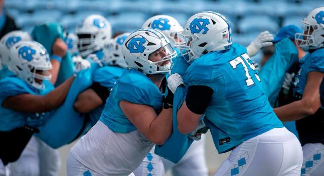 North Carolina offensive lineman Eli Sutton (73) blocks teammate Spencer Rolland (75) during a drill at the Tar Heels’ open practice on Saturday, March 25, 2023 at Kenan Stadium in Chapel Hill. N.C.