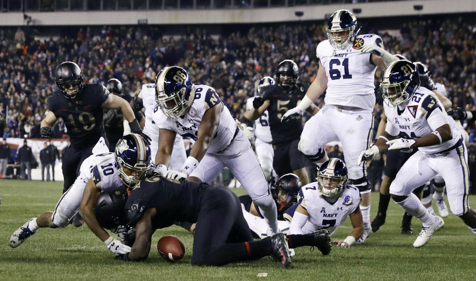 FILE - In this Dec. 8, 2018, file photo, Army's James Gibson (2) recovers a fumble against Navy's Malcolm Perry (10) and OJ Davis (86) during the second half of an NCAA college football game in Philadelphia. The 120th Army-Navy game is set for Saturday in Philadelphia. Army is trying to win its fourth straight game in the series. (AP Photo/Matt Slocum, File)