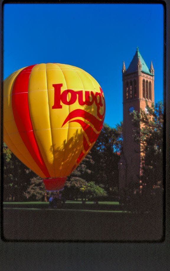 "Cy in the air" is photographed next to Iowa State's Campanile on Central Campus.  It's a 70-foot hot air balloon with Cy on one side and the words Iowa State and logo on the other.