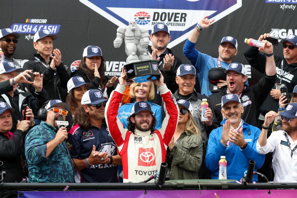 NASCAR Xfinity Series driver Ryan Truex raises the Miles The Monster winners trophy in victory lane after winning the A-GAME 200 at Dover Motor Speedway on April 29, 2023.