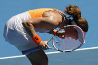 Alize Cornet of France celebrates after defeating Garbine Muguruza of Spain in their second round match at the Australian Open tennis championships in Melbourne, Australia, Thursday, Jan. 20, 2022. (AP Photo/Hamish Blair)