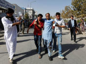 Men help an injured man outside a hospital after a suicide attack in Kabul, Afghanistan July 23, 2016. REUTERS/Mohammad Ismail