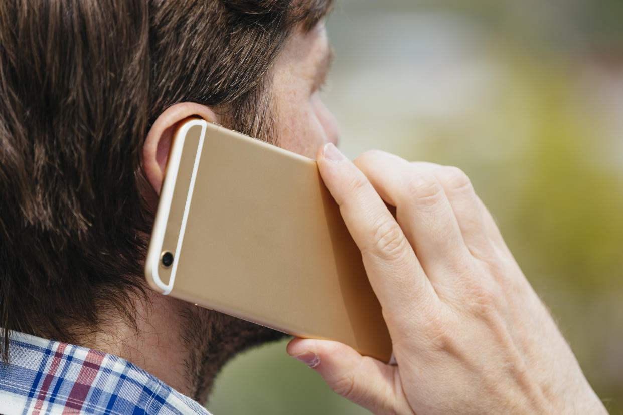 Man talking on a mobile phone, close up