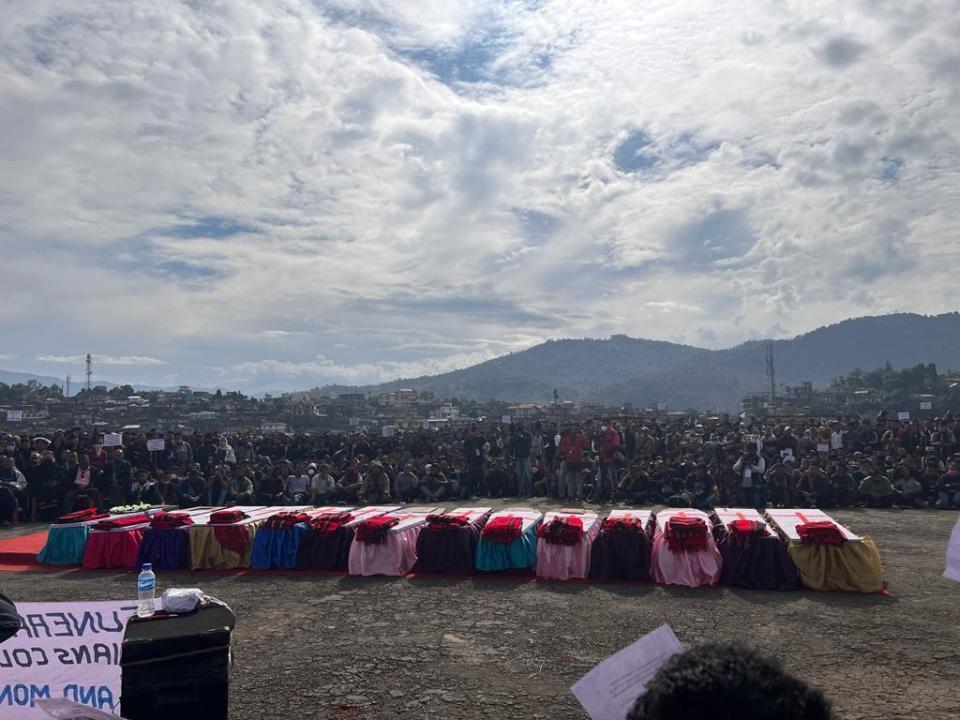 The coffins of people killed by Indian army soldiers on Saturday, who mistakenly believed some of them were militants, and one who was killed when soldiers fired at a crowd of protestors on Sunday, are laid out in a row during a public funeral in Mon, in the northeastern Indian state of Nagaland, Monday, Dec. 6, 2021. (AP Photo/Fifi Konyak)