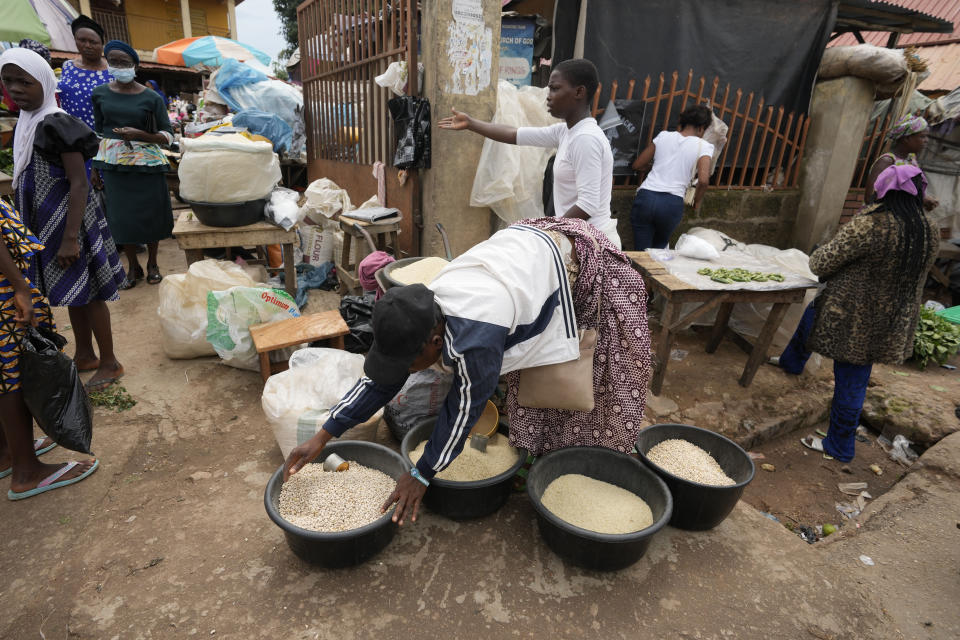 FILE - Women sell food items at a street market in Owo, Southwestern Nigeria, on June 7, 2022. The United Nations is racing to extend a deal that has allowed for shipments of Ukrainian grain through the Black Sea to parts of the world struggling with hunger, helping ease a global food crisis exacerbated by the war that Russia launched more than a year ago. (AP Photo/Sunday Alamba, File)