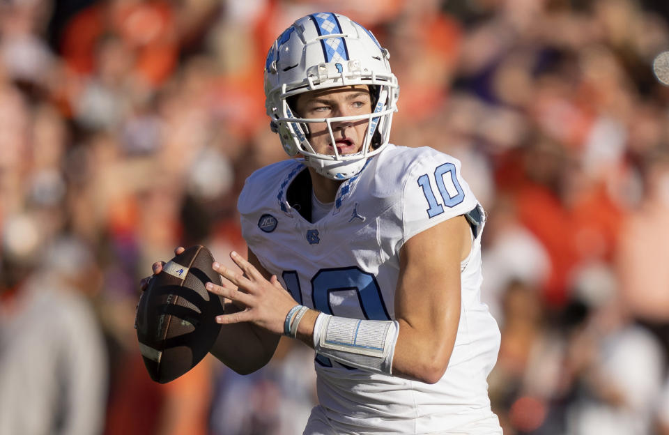 FILE - North Carolina quarterback Drake Maye (10) plays during the first half of an NCAA college football game Saturday, Nov. 18, 2023, in Clemson, S.C. Maye is a possible first round pick in the NFL Draft. (AP Photo/Jacob Kupferman, File)