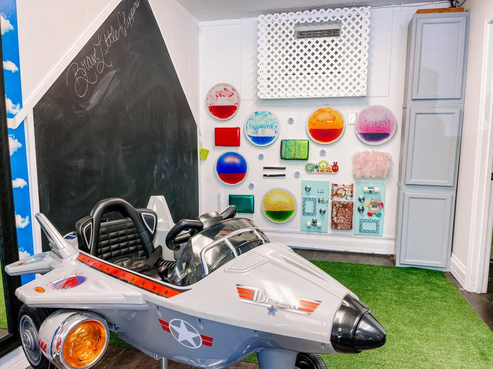 Customers can choose where they sit at Brave Little Clippers in Fountain City on Aug. 3, 2022. There is a chalk wall, artificial grass to sit on and a sensory wall to play.