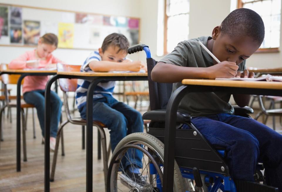 A student in a wheelchair in an elementary school classroom.