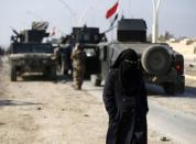 Civilians leave the city to escape from clashes during a battle with Islamic State militants, in al-Zirai district in Mosul, Iraq, January 19, 2017. REUTERS/Muhammad Hamed