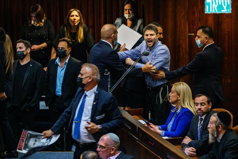 A shouting man is pushed out of legislative chamber