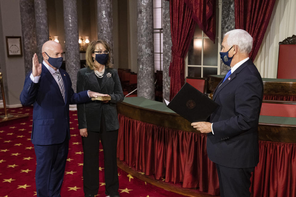 Sen. Mark Kelly, D-Ariz., with his wife former Rep. Gabby Giffords, D-Ariz., participates in a re-enactment of his swearing-in Wednesday, Dec. 2, 2020, by Vice President Mike Pence in the Old Senate Chamber on Capitol Hill in Washington. (Graeme Jennings/Pool via AP)