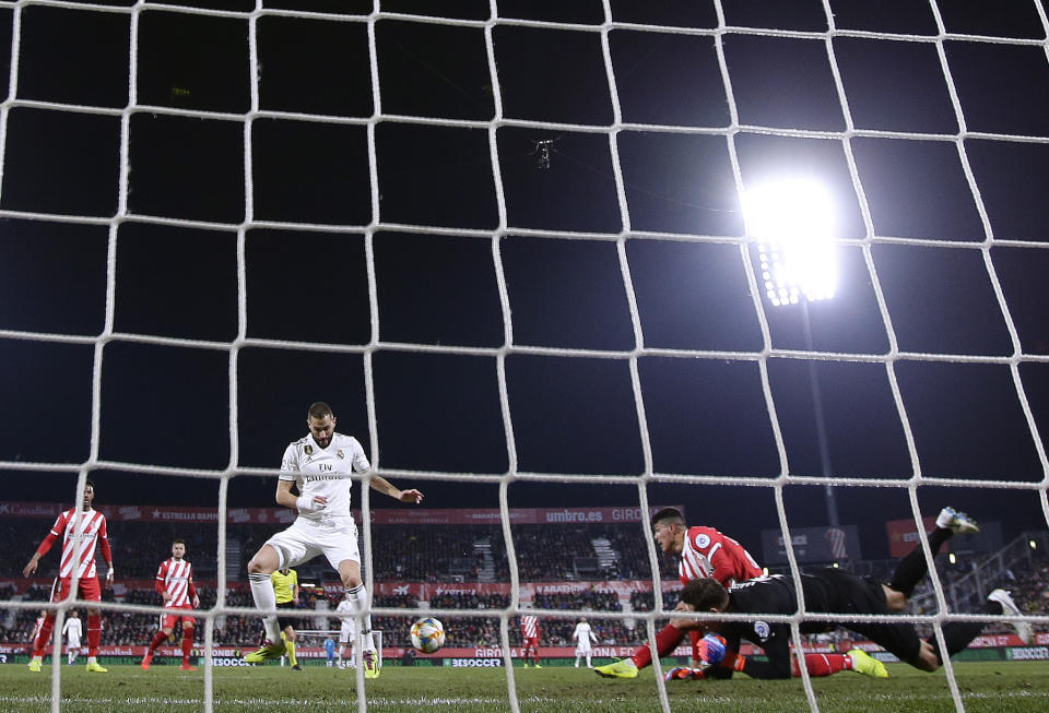 Real Madrid's Benzema, center left, in action during a Spanish Copa del Rey soccer match between Girona and Real Madrid at the Montilivi stadium in Girona, Spain, Thursday, Jan. 31, 2019. (AP Photo/Manu Fernandez)